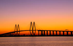 Cable style bridge in Baytown, TX in front of an evening sunset sky.